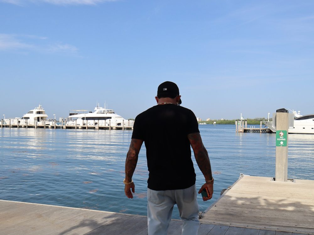 David Sugarman walking the docks at a Miami marina
